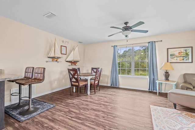 dining room featuring ceiling fan and hardwood / wood-style floors