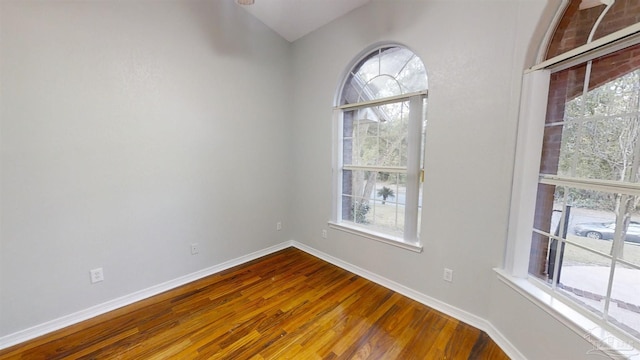 unfurnished room with hardwood / wood-style floors