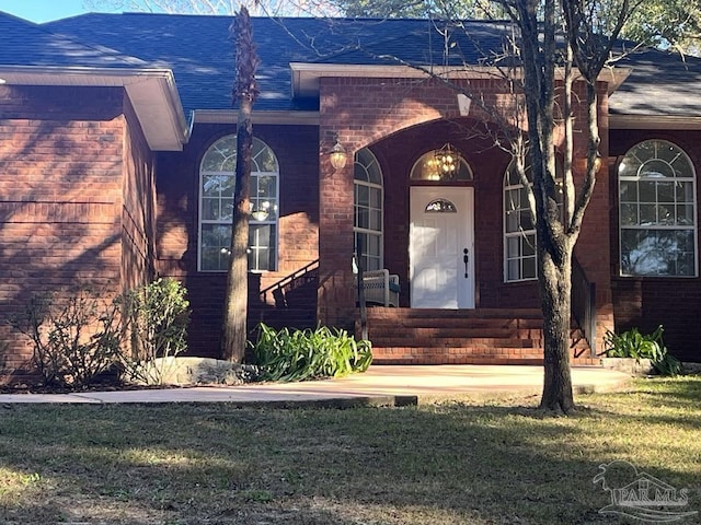 entrance to property featuring a yard