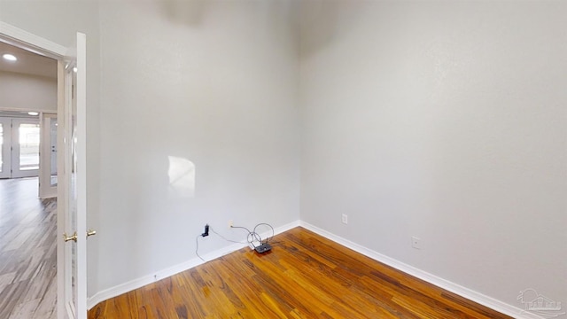 clothes washing area featuring hardwood / wood-style flooring