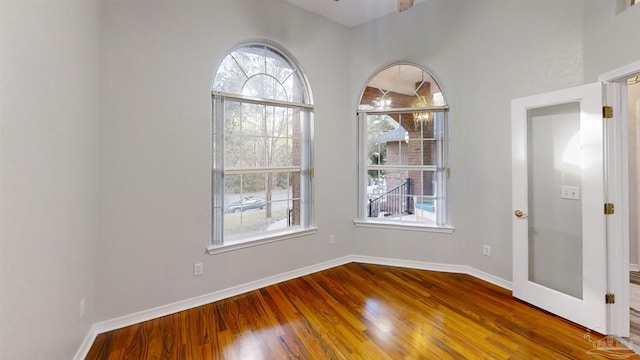 unfurnished room with wood-type flooring