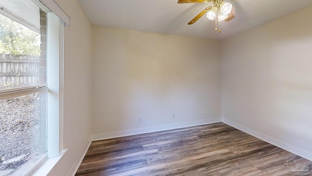 spare room featuring dark hardwood / wood-style floors and ceiling fan