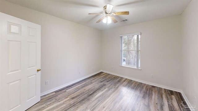 empty room with ceiling fan and hardwood / wood-style floors