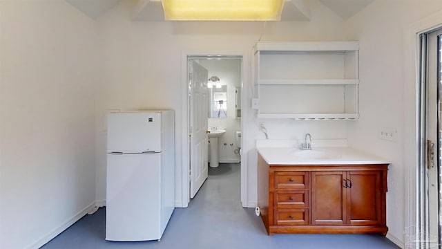 kitchen featuring white fridge and sink