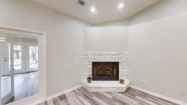 unfurnished living room featuring french doors, lofted ceiling, and wood-type flooring