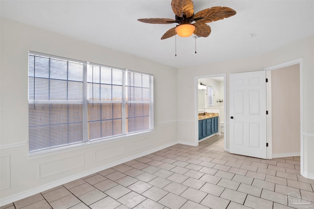 unfurnished room with ceiling fan and light tile patterned flooring