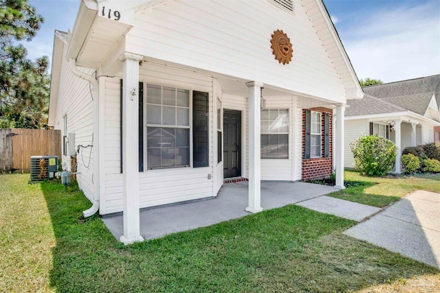 view of front of property with central AC unit and a front lawn