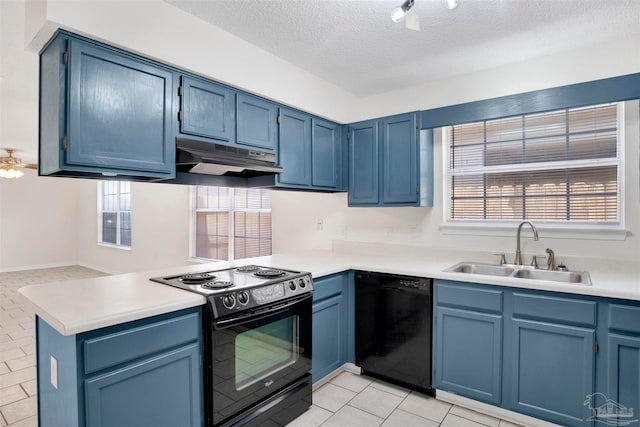 kitchen with black appliances, a textured ceiling, a wealth of natural light, and sink