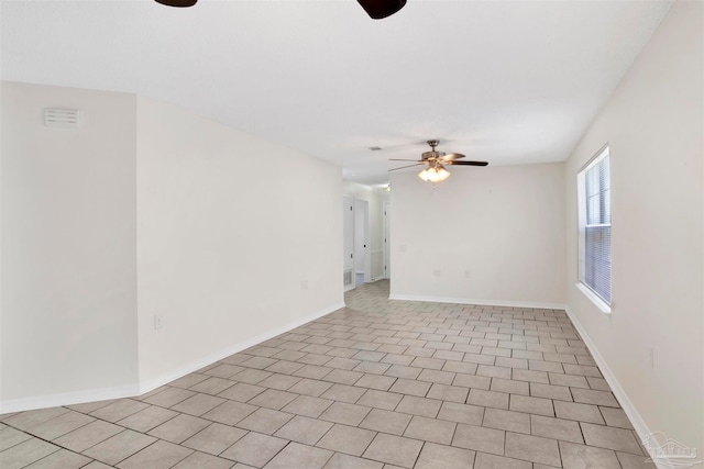 tiled empty room with ceiling fan