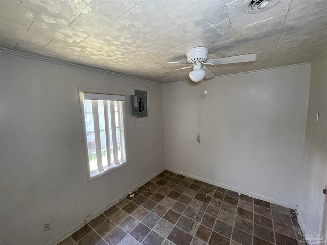 tiled spare room with electric panel and ceiling fan