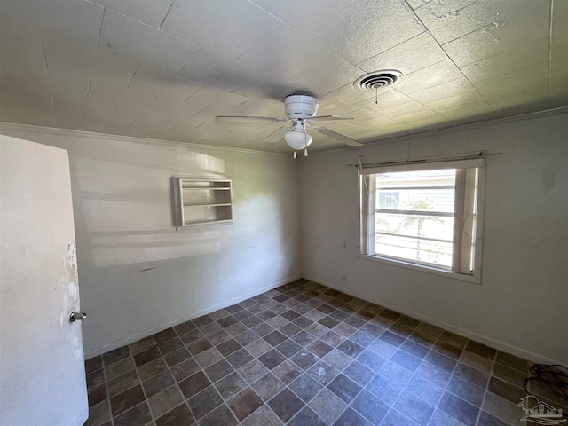 tiled spare room featuring ceiling fan