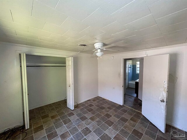 unfurnished bedroom featuring a closet, ceiling fan, and tile patterned flooring