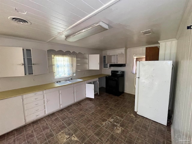 kitchen with black electric range, white cabinets, dark tile patterned flooring, white refrigerator, and sink