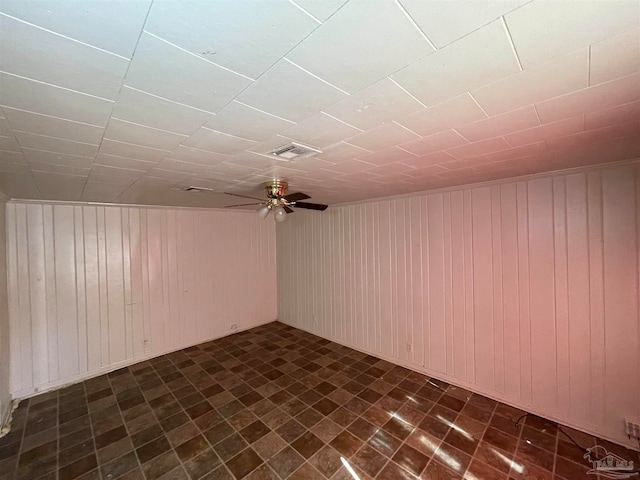 bonus room featuring dark tile patterned floors and ceiling fan