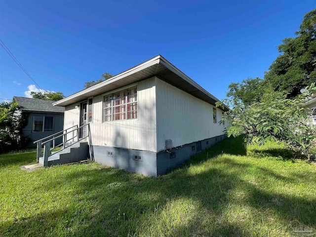 view of side of home featuring a yard