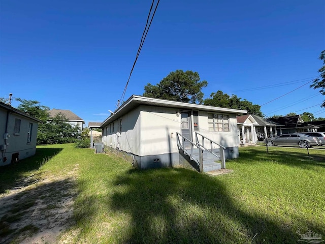 rear view of house featuring a yard