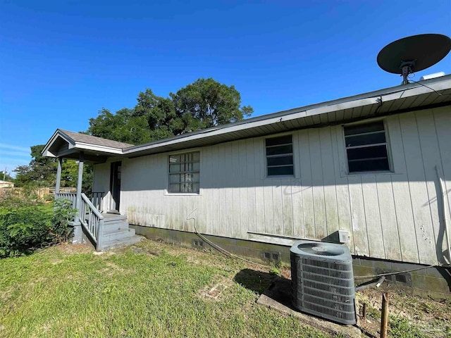 view of property exterior featuring cooling unit and a yard