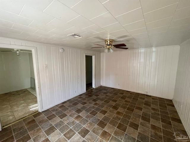 empty room featuring dark tile patterned floors and ceiling fan