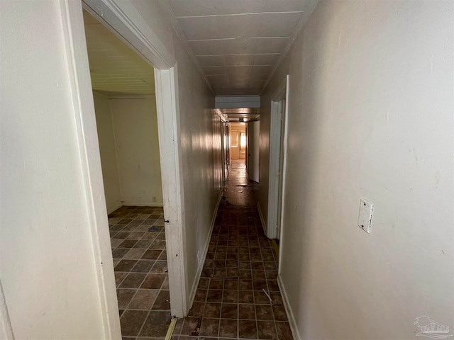 corridor featuring dark tile patterned flooring