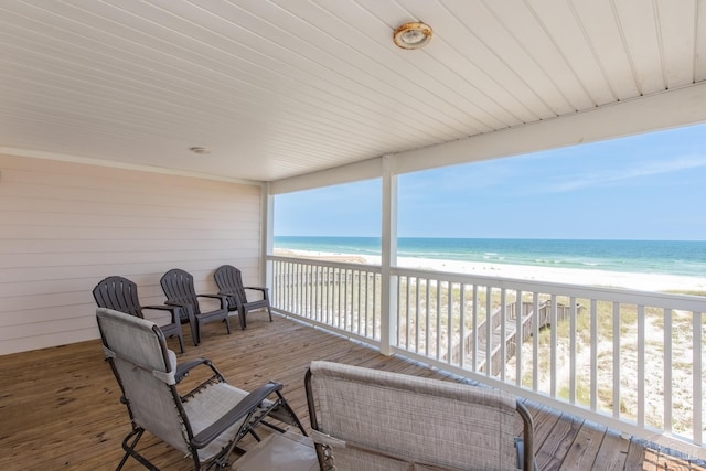 view of patio featuring a water view and a view of the beach