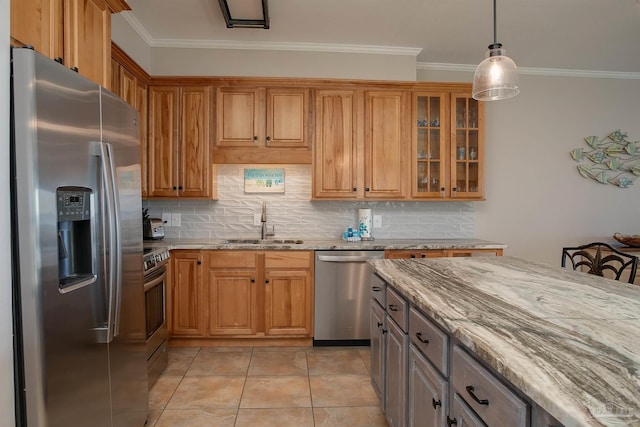 kitchen featuring light stone counters, a sink, stainless steel appliances, backsplash, and ornamental molding