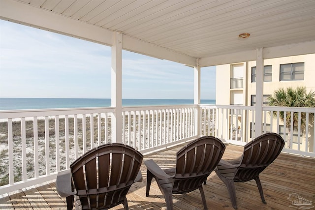 balcony featuring a water view and a beach view