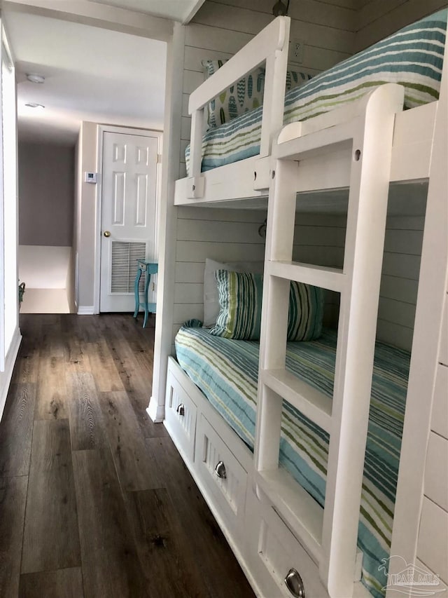 mudroom featuring wood walls, visible vents, and dark wood-style floors