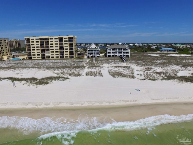 aerial view with a water view and a beach view