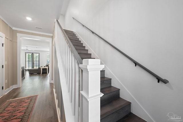 stairs featuring hardwood / wood-style flooring, ornamental molding, and french doors