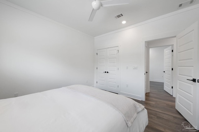 bedroom with crown molding, dark wood-type flooring, and ceiling fan