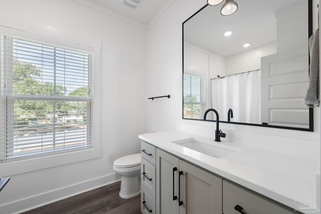 bathroom with toilet, ornamental molding, vanity, curtained shower, and hardwood / wood-style floors