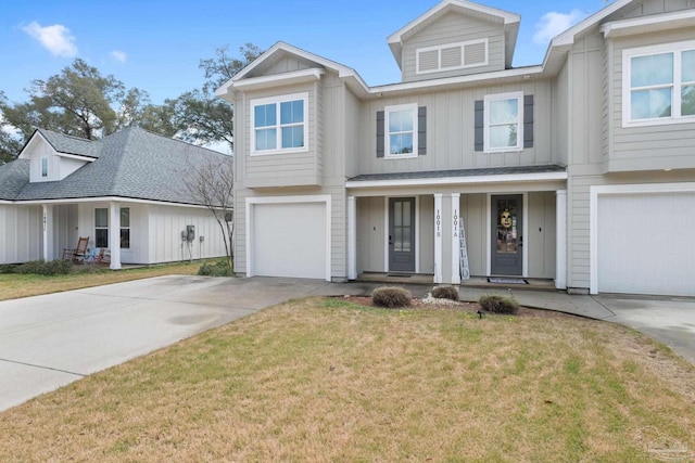 view of front facade featuring a garage, covered porch, and a front yard