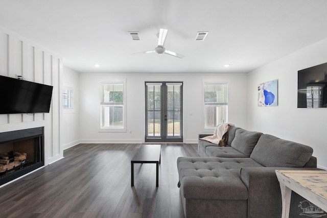 living room featuring french doors, a fireplace, dark hardwood / wood-style floors, and ceiling fan