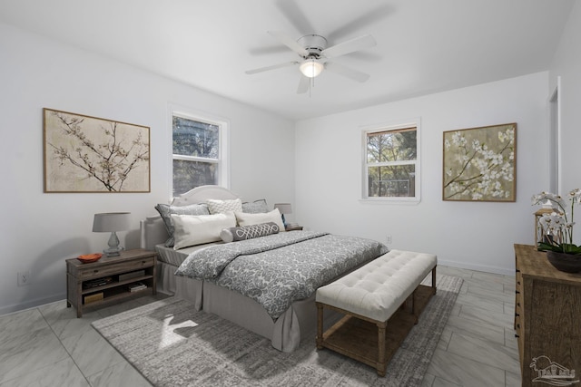 bedroom with ceiling fan and baseboards