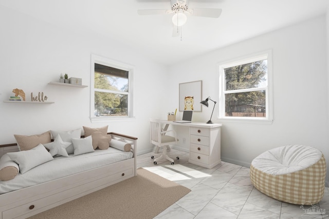 sitting room featuring baseboards, marble finish floor, a wealth of natural light, and a ceiling fan