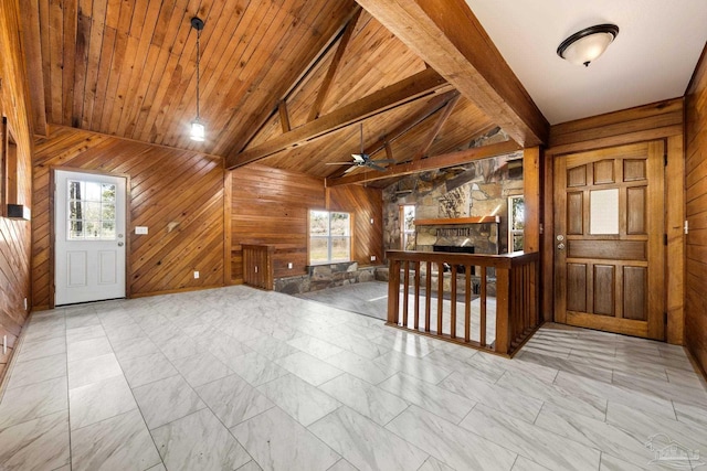 foyer featuring wood ceiling, a fireplace, and wooden walls