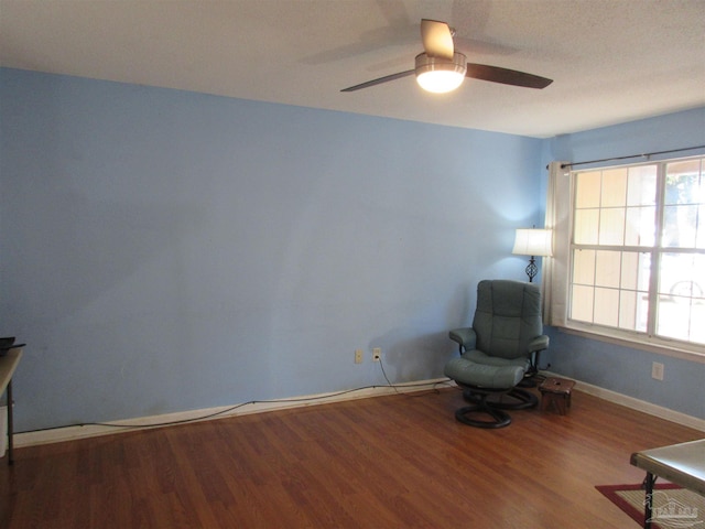 unfurnished room featuring a ceiling fan, baseboards, and wood finished floors