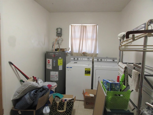 laundry room featuring water heater, laundry area, separate washer and dryer, and light tile patterned flooring