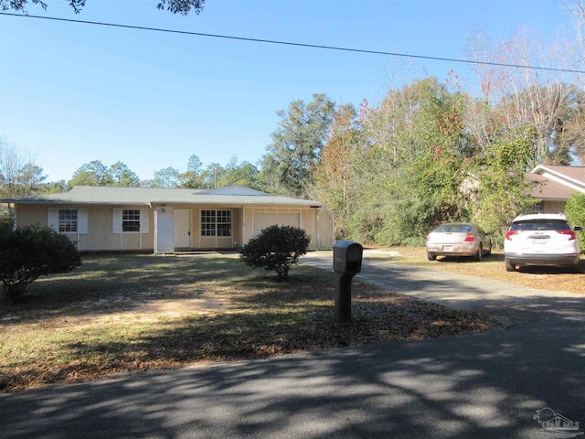 single story home featuring an attached garage and driveway