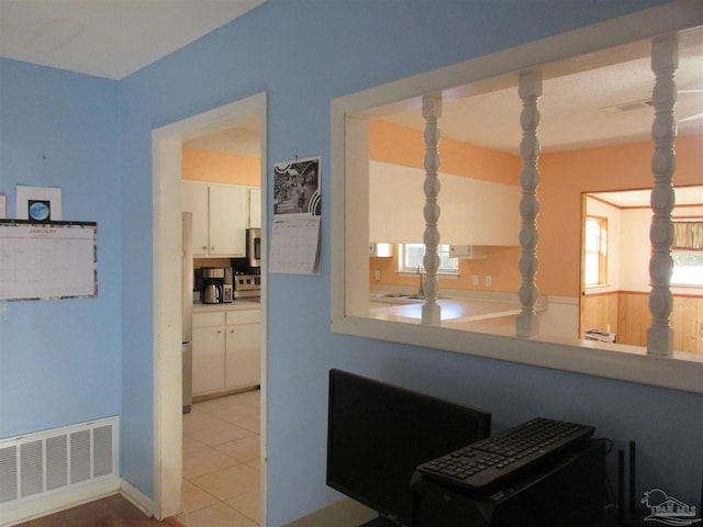 interior space featuring a wainscoted wall and visible vents