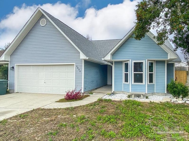 view of front of home with a garage and a front yard