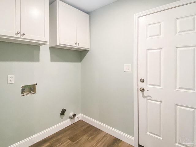 washroom with cabinets, hookup for a washing machine, and dark hardwood / wood-style flooring