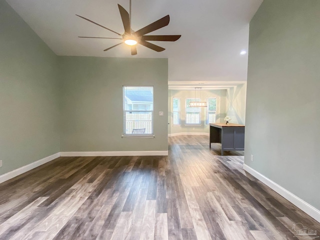 unfurnished room featuring dark wood-type flooring and ceiling fan