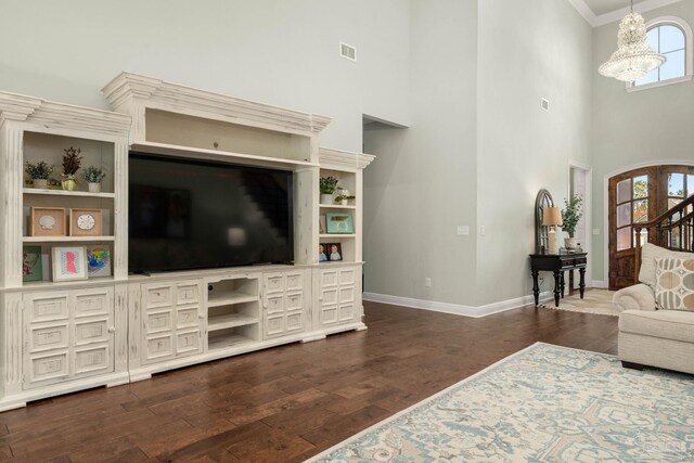 8901 Salt Grass Dr, Pensacola, FL 32526 - living area featuring baseboards, a towering ceiling, dark wood-style flooring, crown molding, and a chandelier