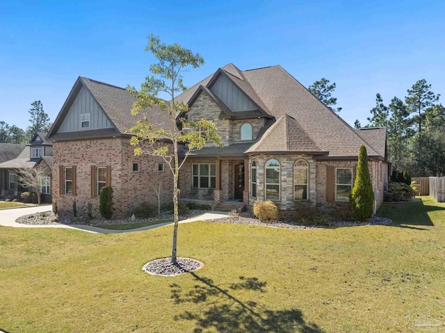 view of front of property featuring brick siding, roof with shingles, board and batten siding, and a front yard