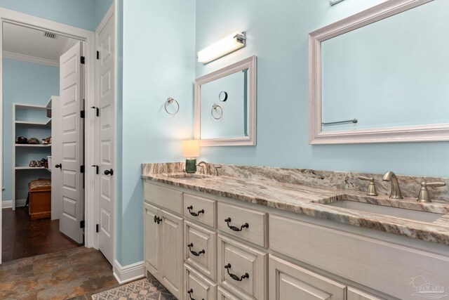 8901 Salt Grass Dr, Pensacola, FL 32526 - bathroom with ornamental molding, a sink, baseboards, and double vanity