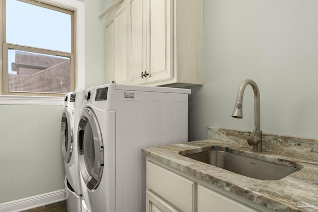 8901 Salt Grass Dr, Pensacola, FL 32526 - laundry room with baseboards, cabinet space, a sink, and washing machine and clothes dryer
