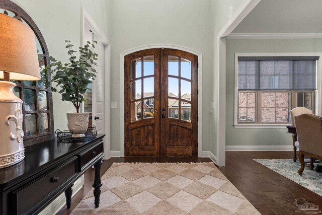 8901 Salt Grass Dr, Pensacola, FL 32526 - foyer featuring baseboards, arched walkways, ornamental molding, wood finished floors, and french doors
