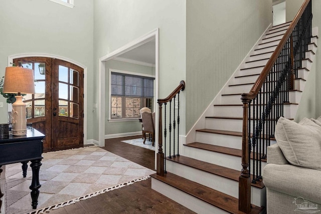 8901 Salt Grass Dr, Pensacola, FL 32526 - entryway featuring french doors, a high ceiling, wood finished floors, baseboards, and stairs
