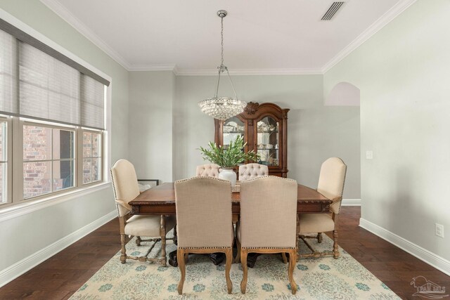 8901 Salt Grass Dr, Pensacola, FL 32526 - dining area featuring baseboards, visible vents, ornamental molding, dark wood-type flooring, and an inviting chandelier